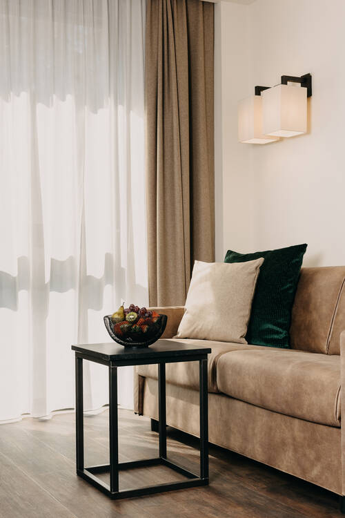 Detailaufnahme Wohnzimmer mit Sofa und Tisch.