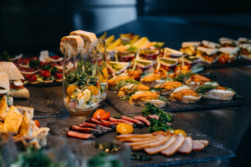Close-up of a coffee break with sandwiches and cold cuts.